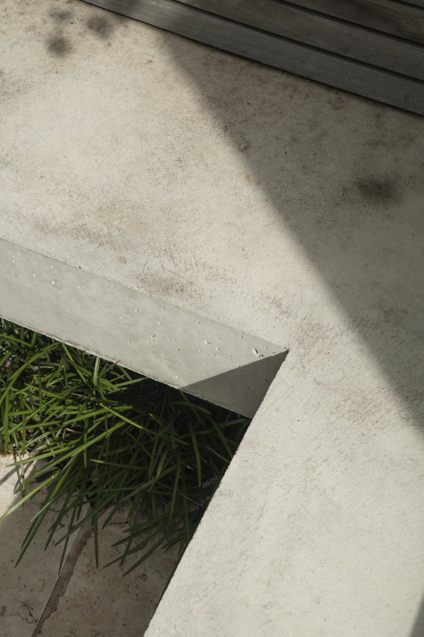 The concrete bench meeting the paving, mondo grass set into the join