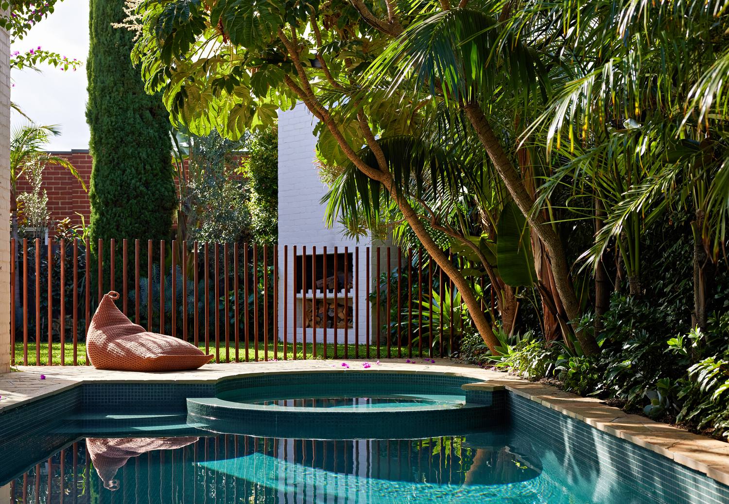 The pool looking across to the fireplace through the copper rod fence